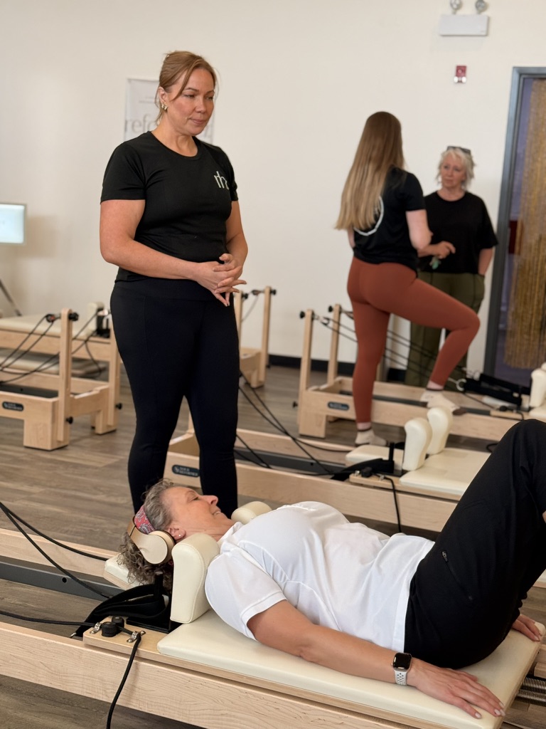 ReformHer Pilates session with instructor and clients in the Lethbridge studio
